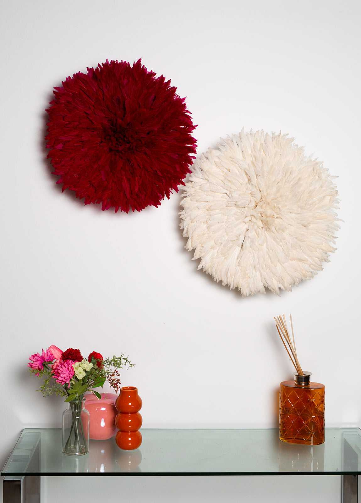 Handmade Juju hat wall decor in dark red and white, perfect for interior design and Christmas gifts. Vibrant feather wall art in two-tone design