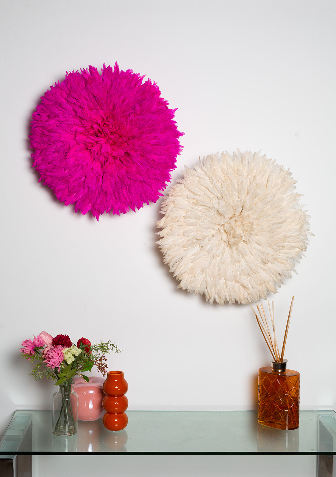 Handmade Juju hat wall decor in pink and white, perfect for interior design and Christmas gifts. Vibrant feather wall art in two-tone design