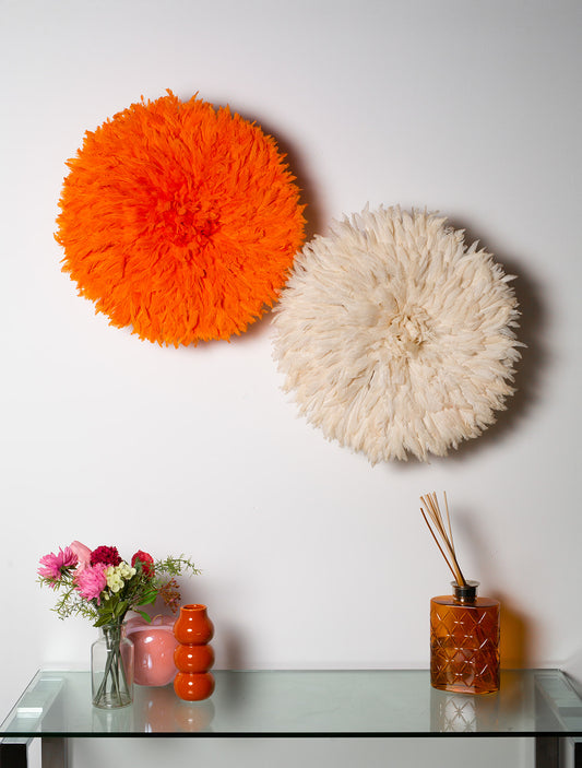 Handmade Juju hat wall decor in pink and white, perfect for interior design and Christmas gifts. Vibrant feather wall art in two-tone design